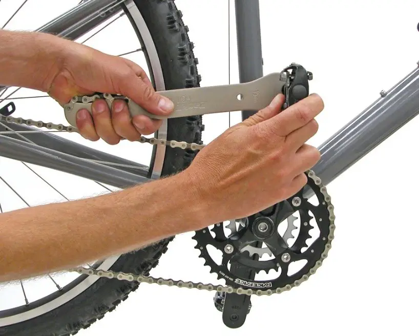 Position the wrench on your bike’s right pedal